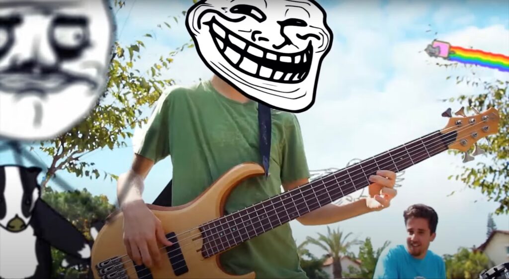A guy plays the guitar with a funny face