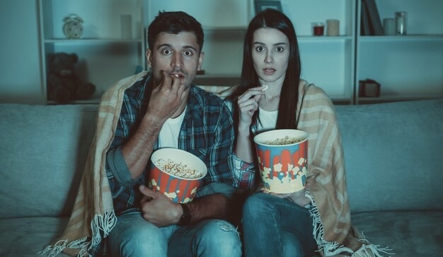 Guy and girl watching a movie
