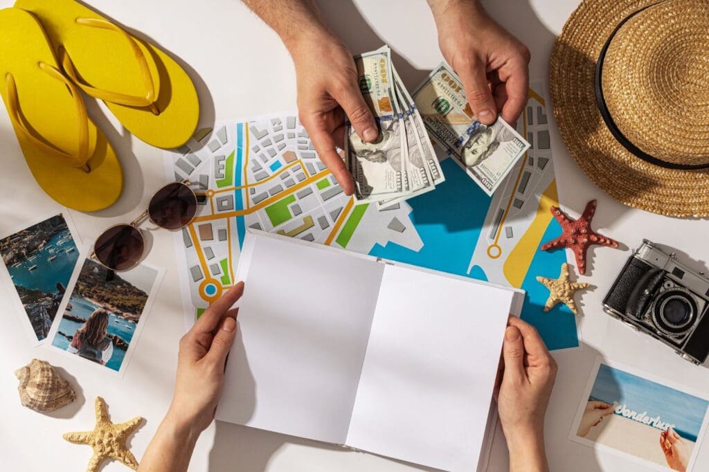 Top view of hands holding notebook and cash preparing for travel