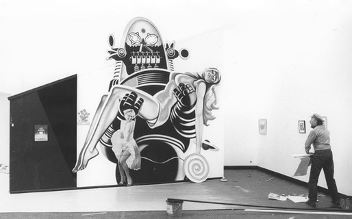 Man painting a picture on the wall